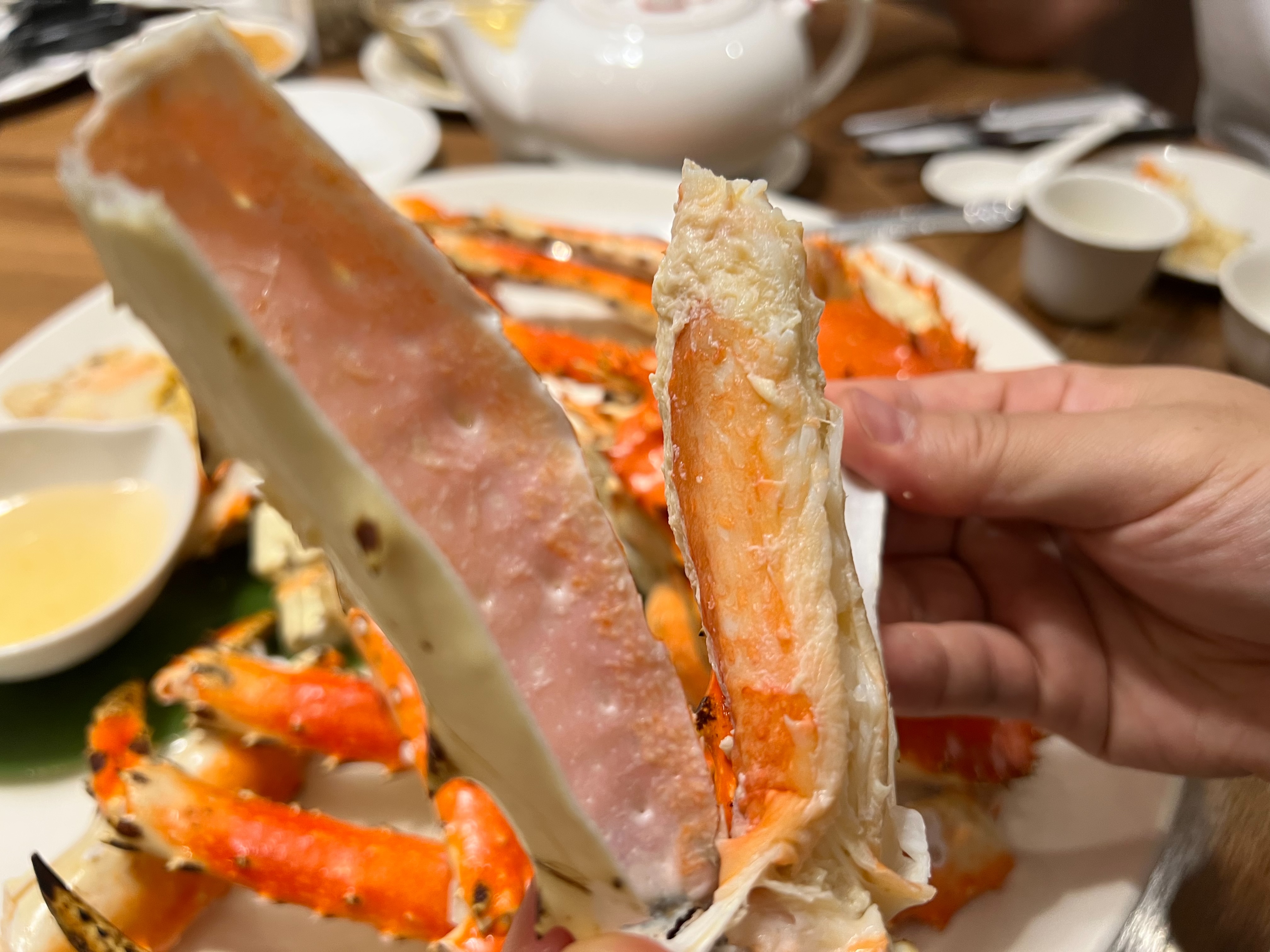 手持一段飽滿細緻的帝王蟹腿肉
